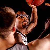 Picture of a man playing basketball while wearing an eyetracker